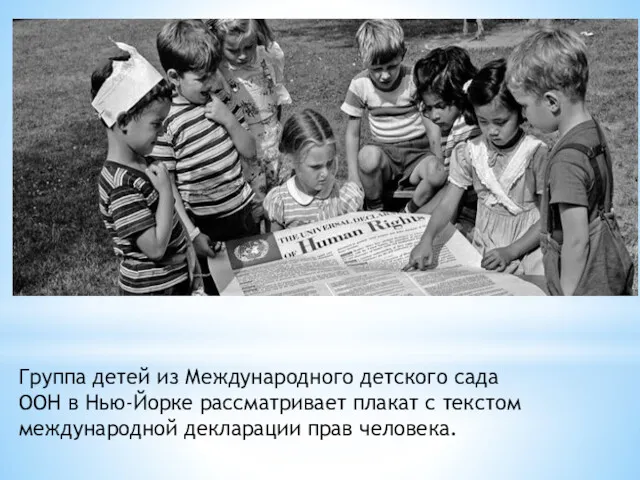 Группа детей из Международного детского сада ООН в Нью-Йорке рассматривает плакат с текстом