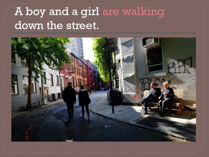 A boy and a girl are walking down the street.