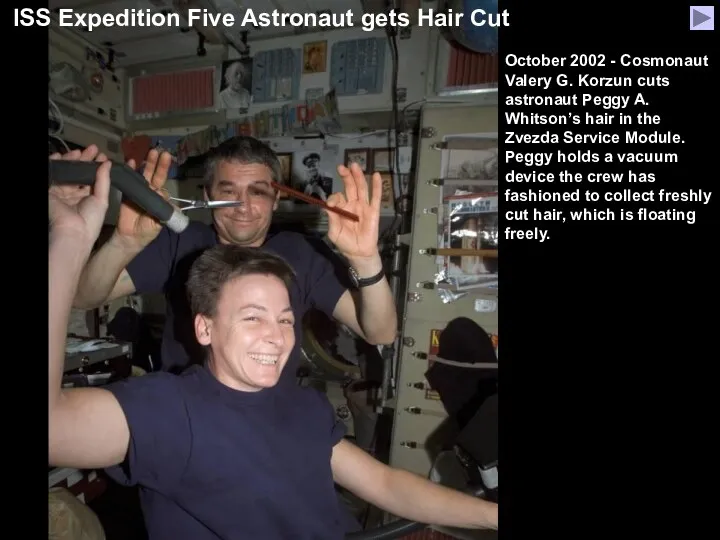 October 2002 - Cosmonaut Valery G. Korzun cuts astronaut Peggy