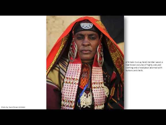 A female murzuq band member wears a traditional costume of