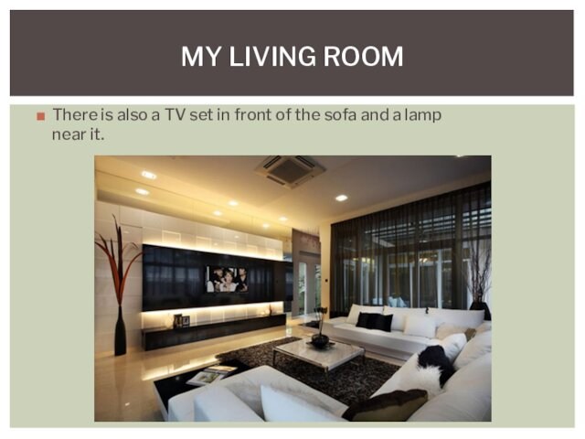 There is also a TV set in front of the sofa and a lamp near